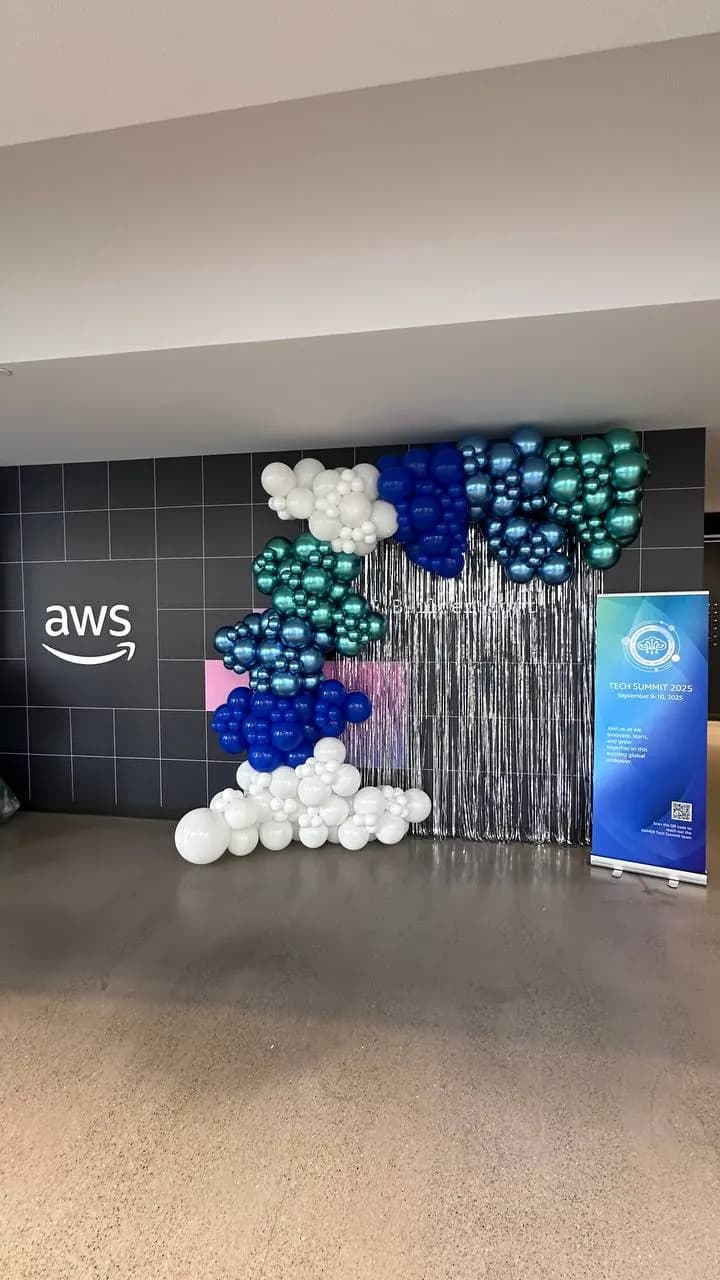 Metallic organic balloon backdrop for AWS at the Tech Summit 2025 in San Francisco, California.