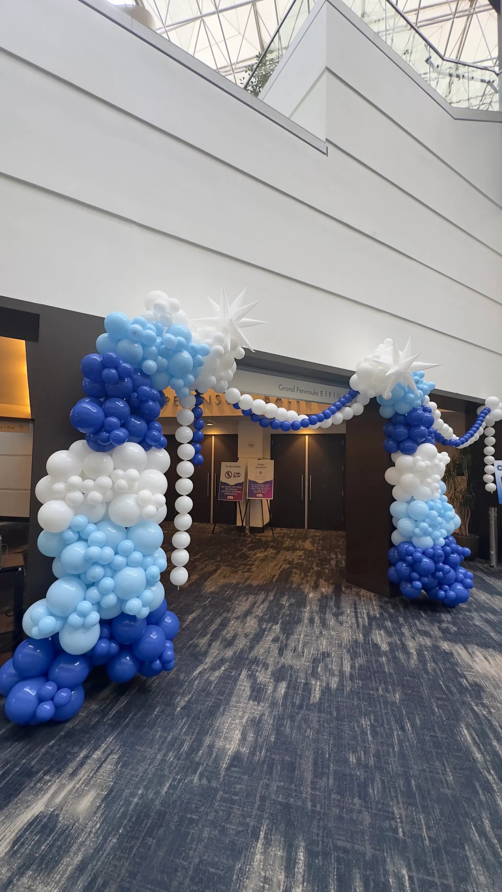 Conference Event in Hyatt Regency San Francisco Airport: blue-and-white entrance balloon arches, view 2 of 3.