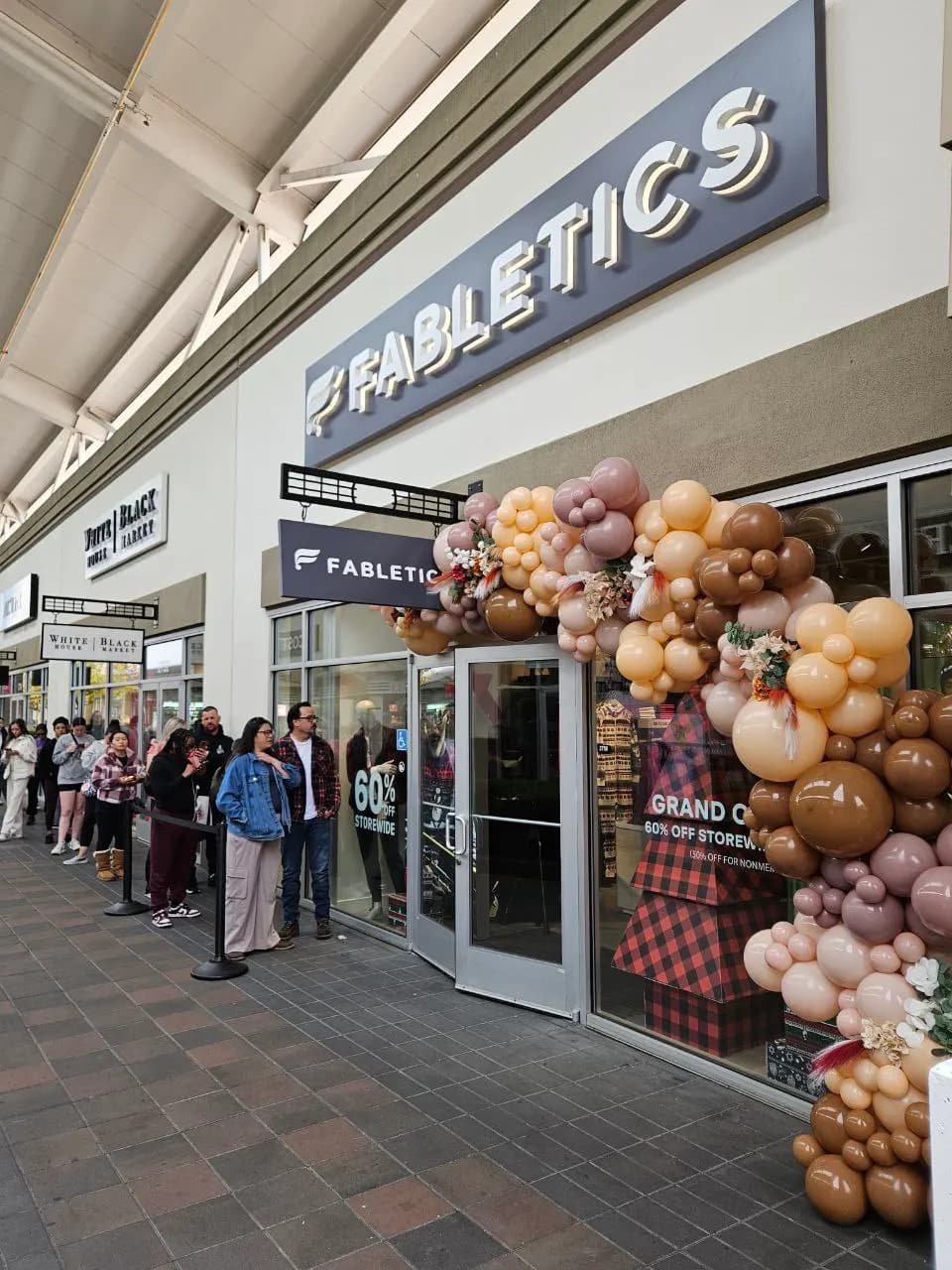Fabletics' Store Grand Opening in San Francisco Bay Area: branded storefront balloon arch, view 2 of 3.