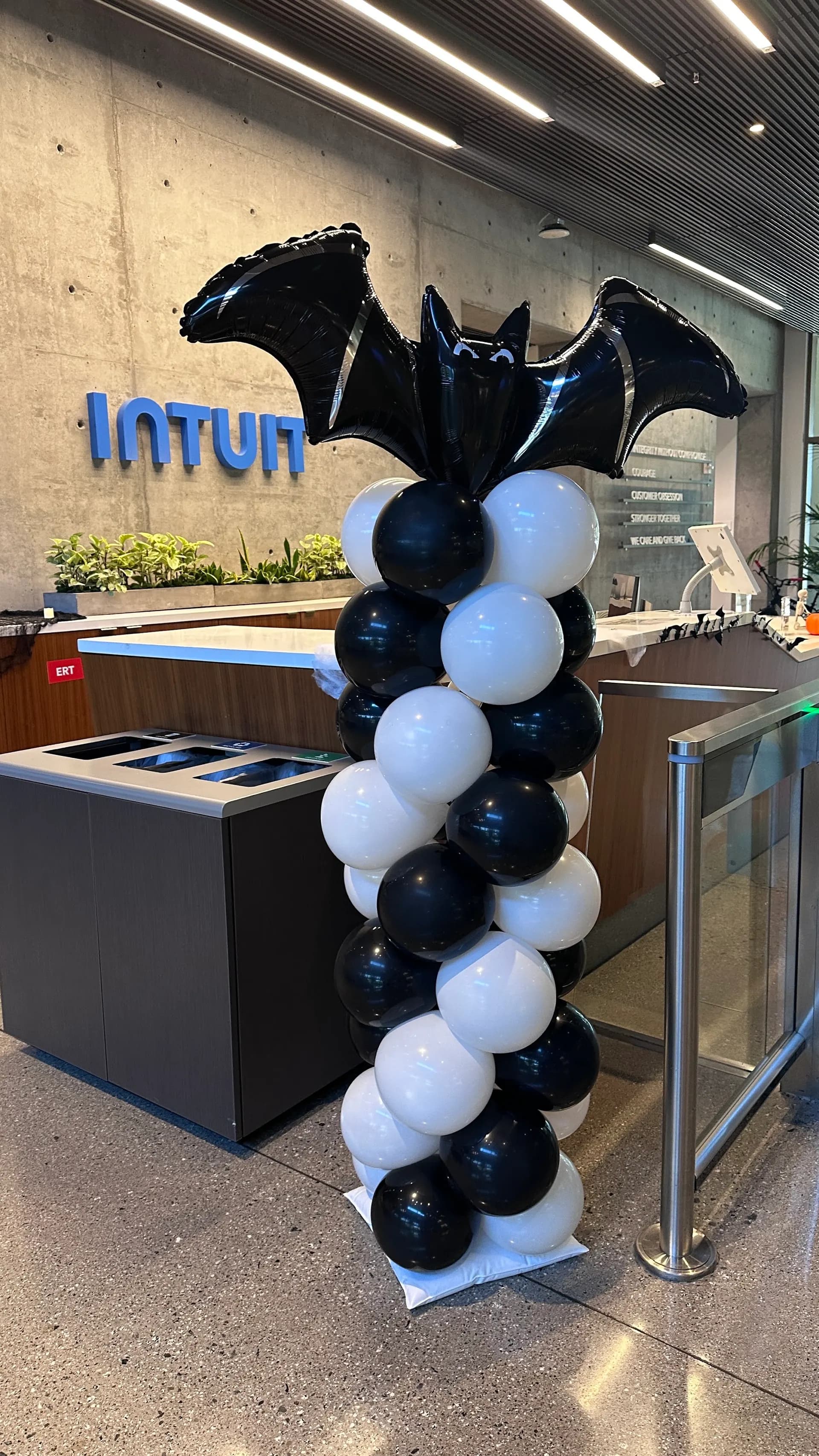 Intuit's Halloween Office Event in Silicon Valley, California: spider-themed arch and balloon column, view 2 of 2.