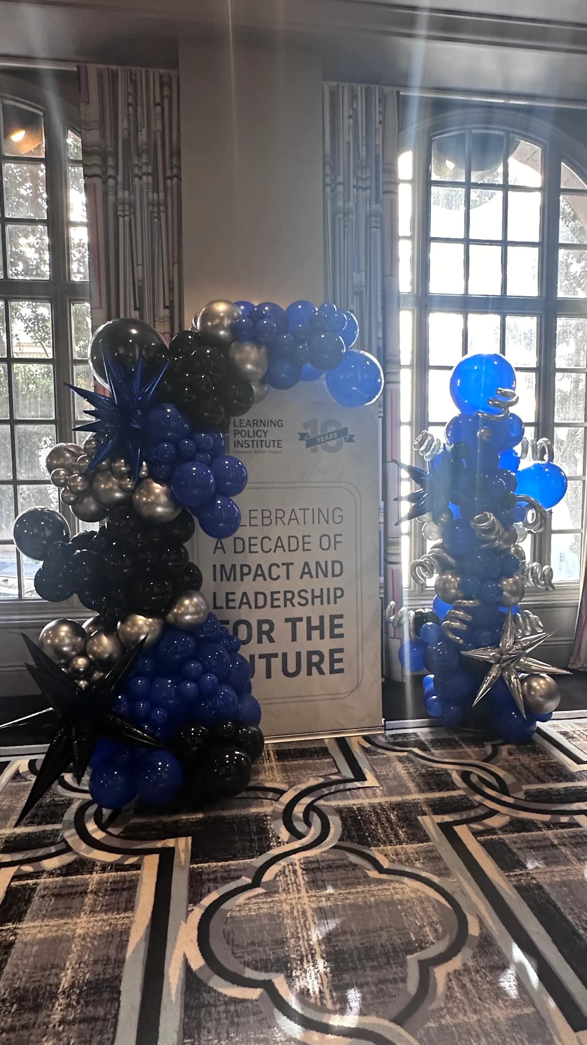 Branded balloon columns and backdrop for Learning Policy Institute at the 10-Year Anniversary Celebration in San Francisco Bay Area.