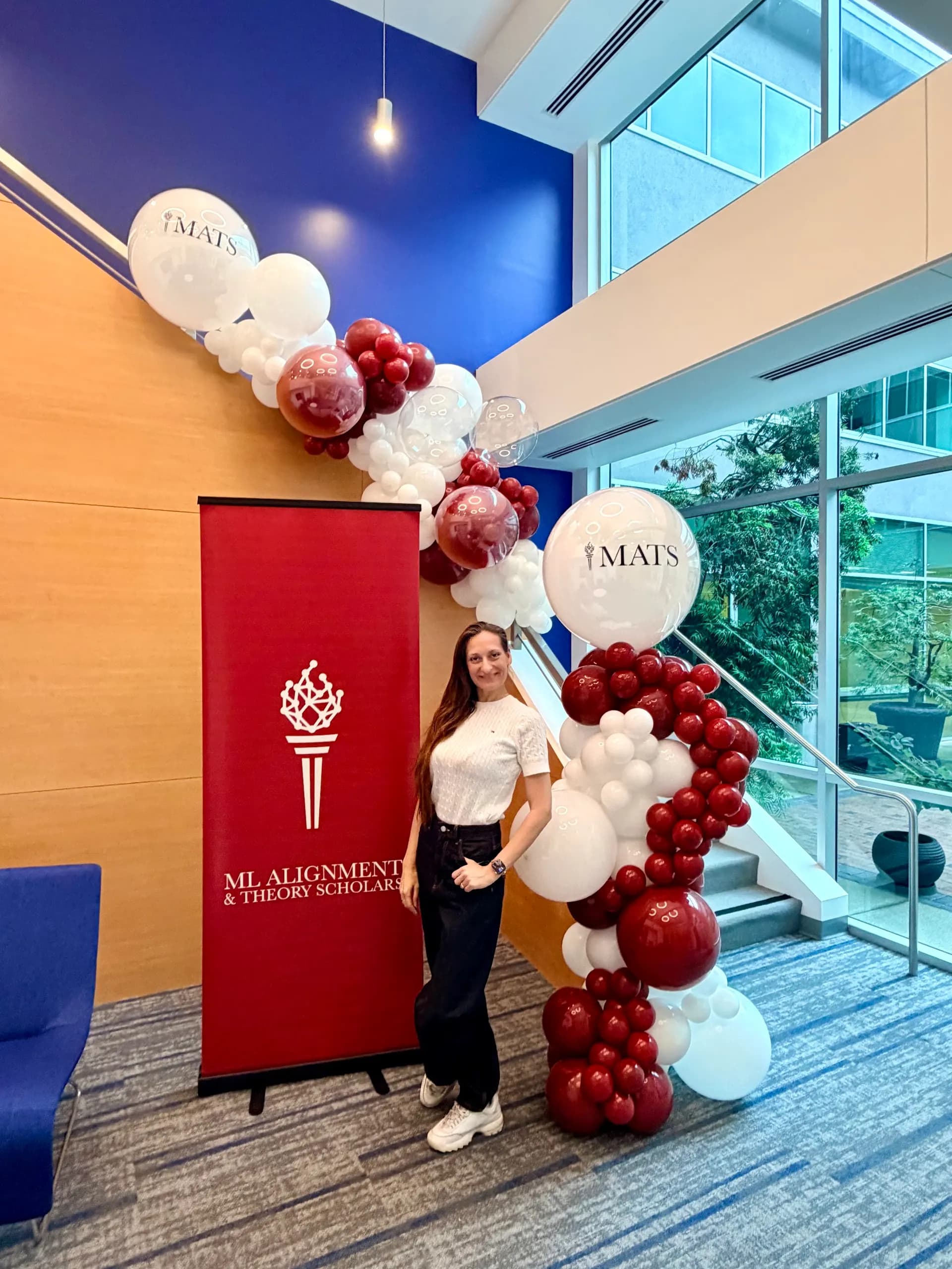 MATS's ML Alignment & Theory Scholars Event in San Francisco Bay Area: organic balloon garland around a branded event banner, view 2 of 2.