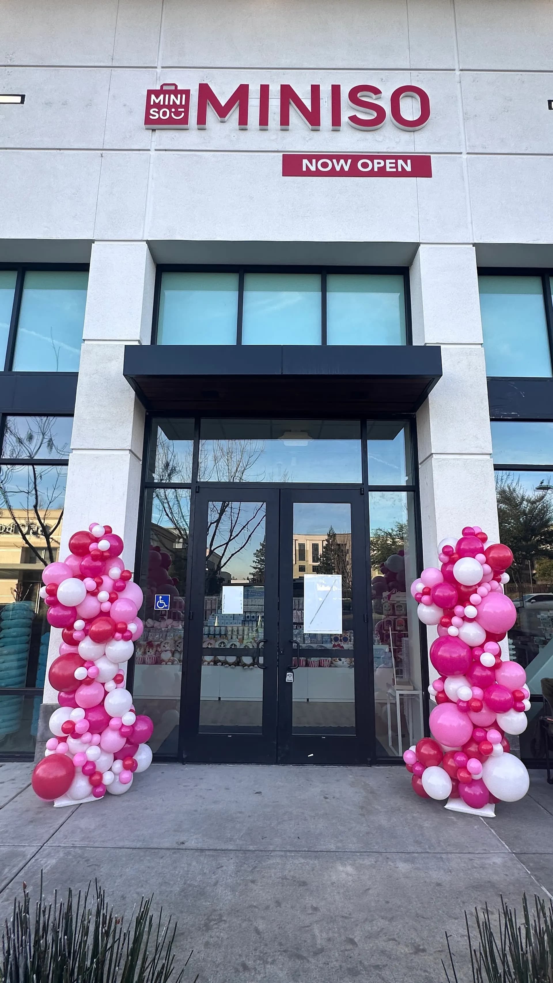 Branded entrance balloon columns for MINISO at the Store Grand Opening in San Francisco Bay Area.