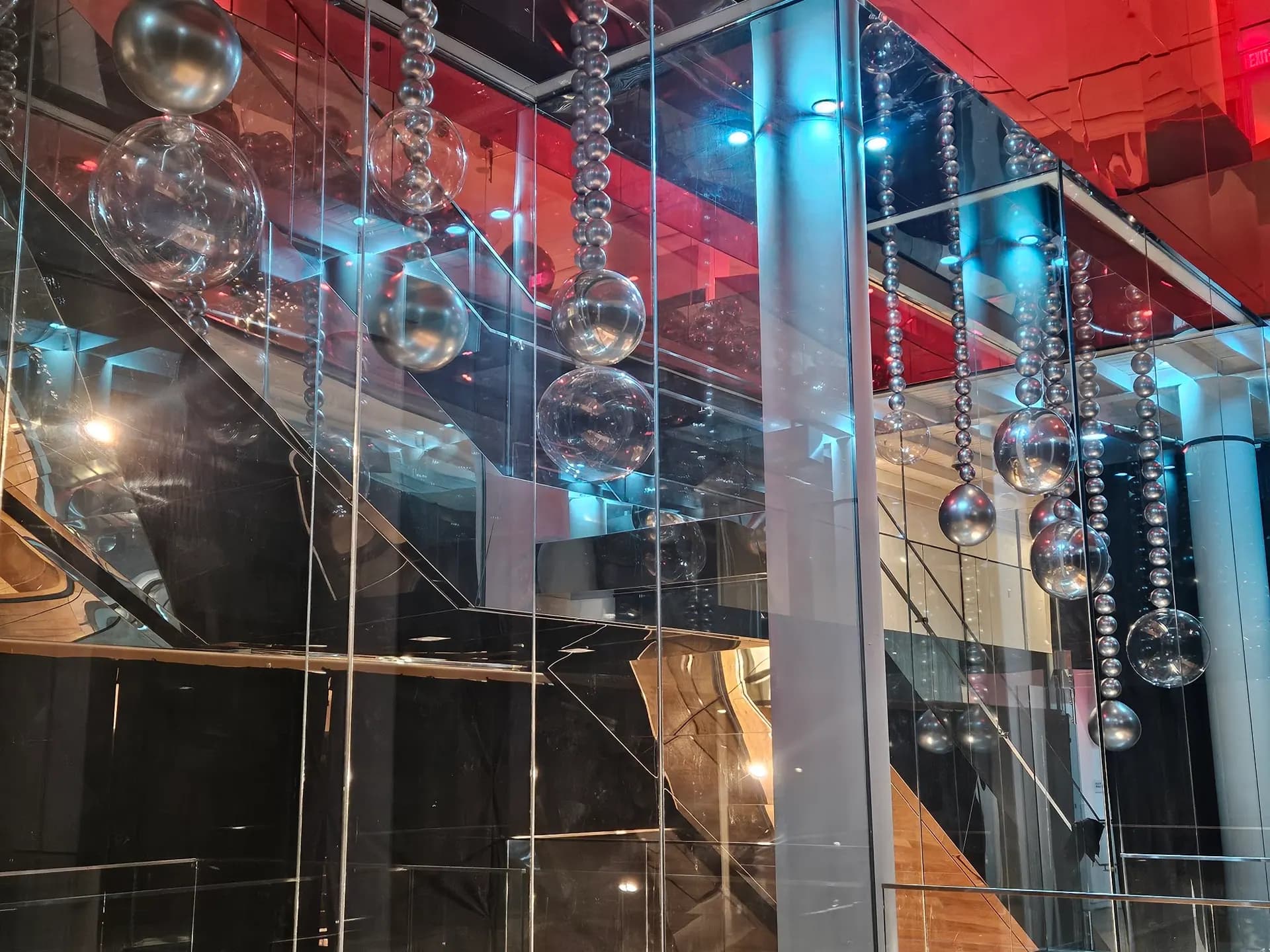 Hanging silver balloon sphere installation at the Modern Corporate Event in San Francisco, California.