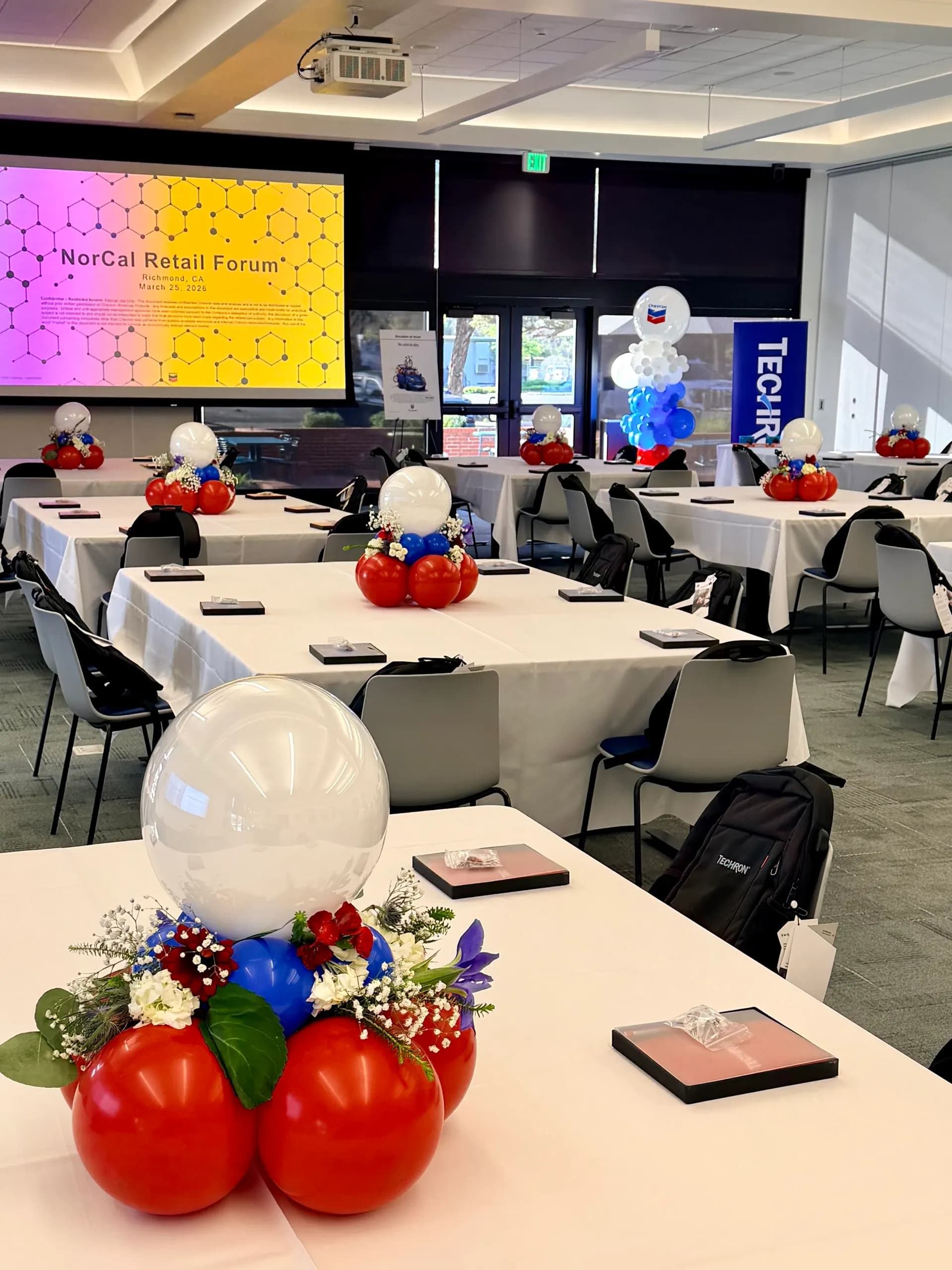 Balloon arch and floral balloon centerpieces for NorCal Retail Forum at the Retail Industry Forum in Richmond, California.