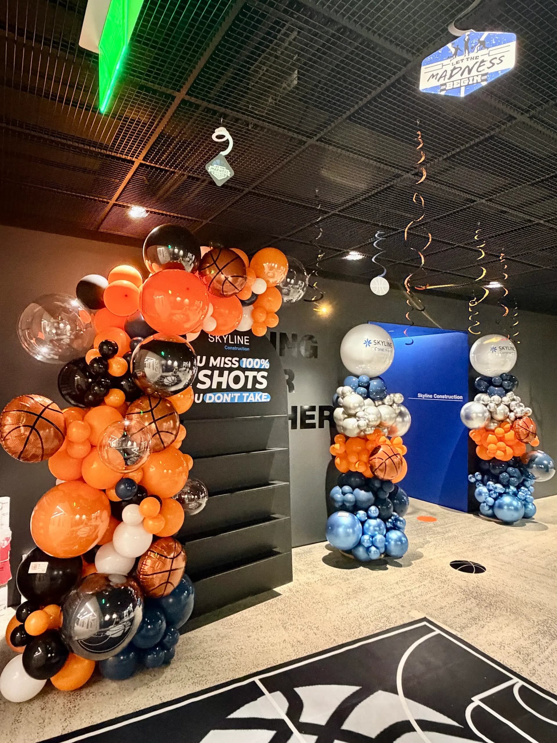 Skyline Construction's March Madness Office Event in San Francisco Bay Area: basketball-themed garland and branded columns, view 2 of 6.