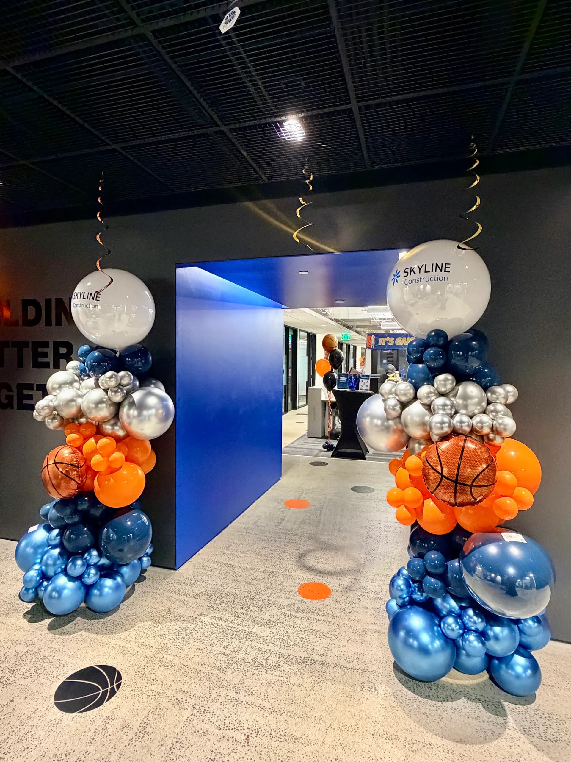 Basketball-themed garland and branded columns produced by Balloon Décor for Skyline Construction in San Francisco Bay Area, view 3.